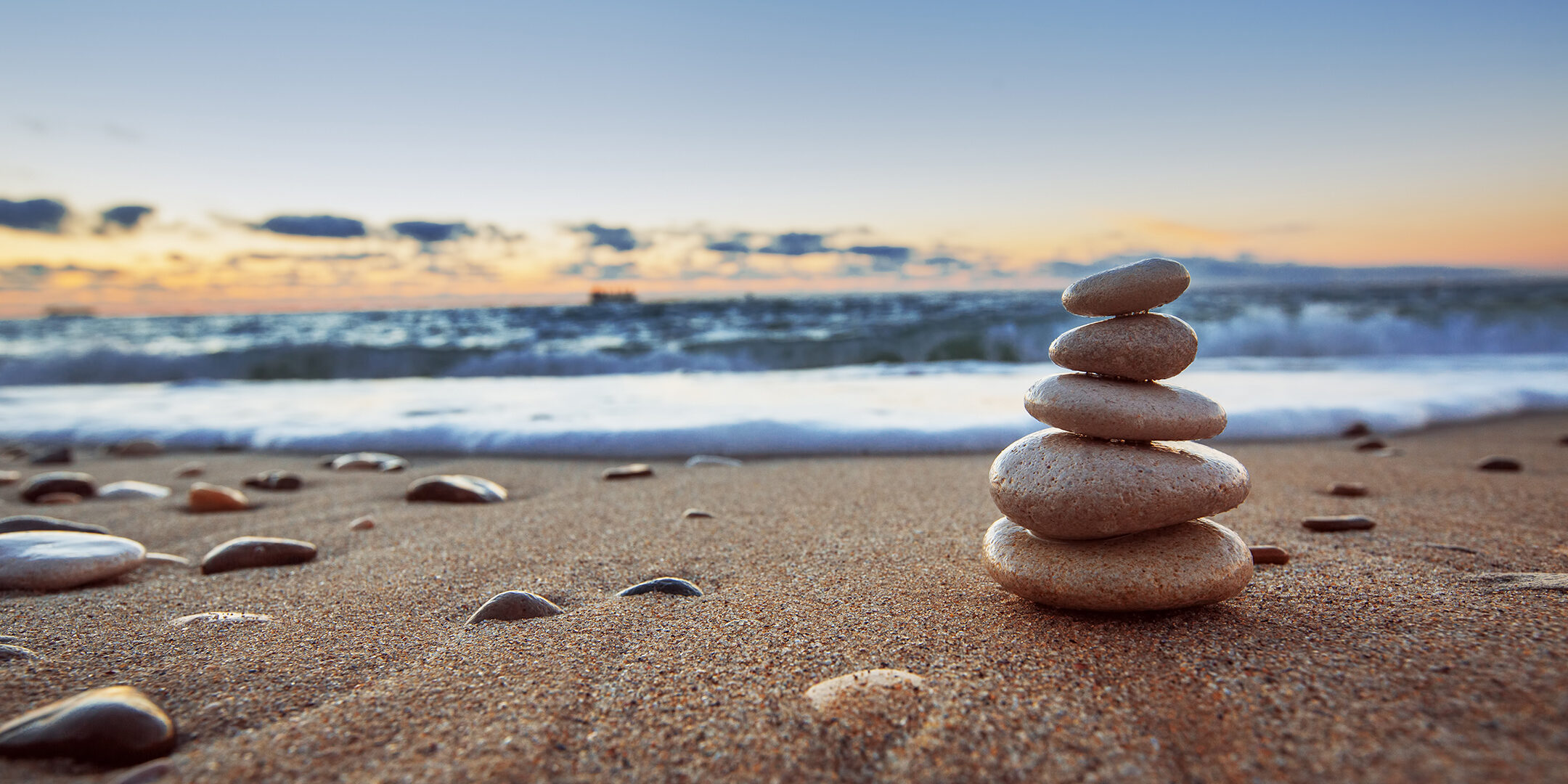 Stones balance on beach, sunrise shot